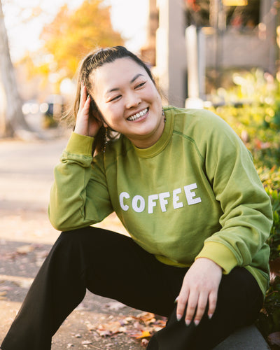 Green Crewneck Sweater with "COFFEE" sewn on and a Temple Coffee patch.