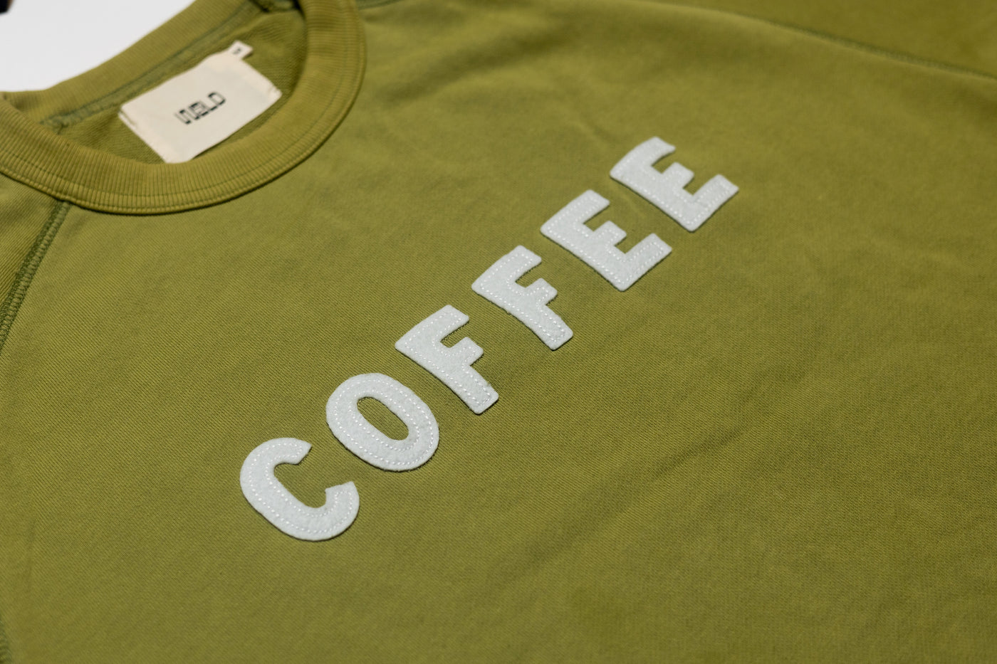 Green Crewneck Sweater with "COFFEE" sewn on.