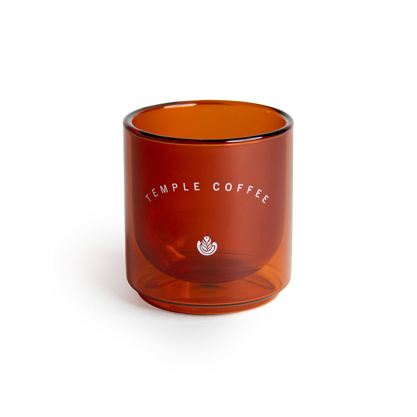 Amber glass tumbler with 'Temple Coffee' branding on a white background