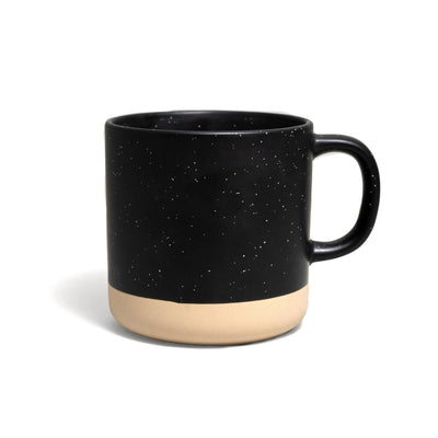 Backside of a black mug with subtle speckles and an unglazed base.