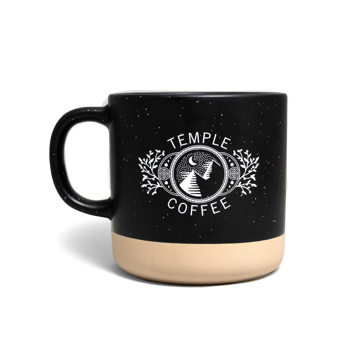 Black mug with subtle speckles and an unglazed base, printed with a design featuring mountains, stars, moons, winterberries, and the words 'TEMPLE COFFEE.'