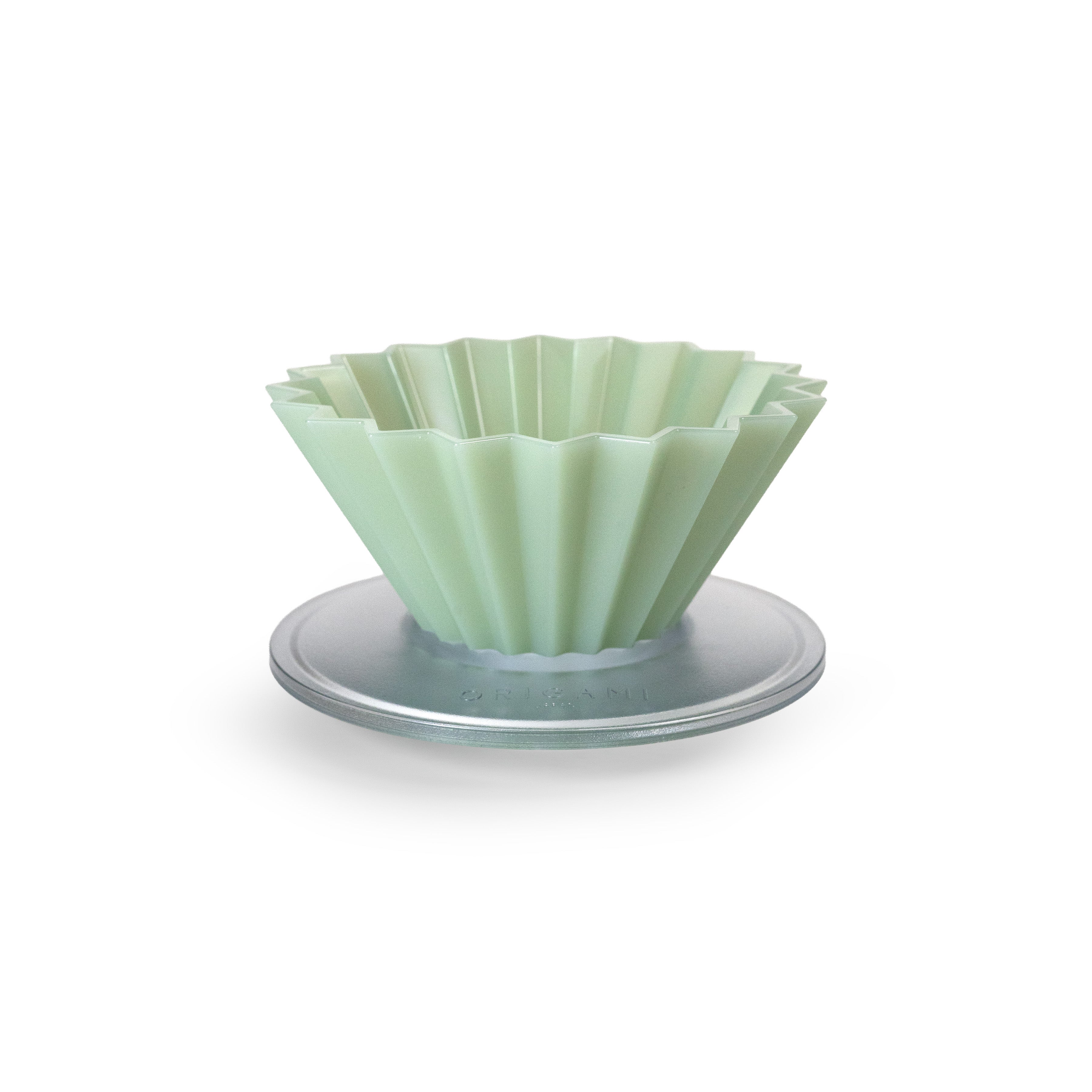 Matte green fluted pour over dripper on a white background.
