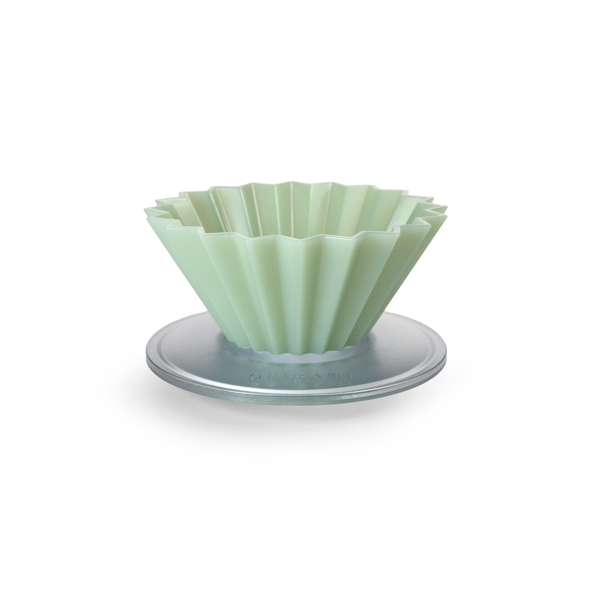 Matte green fluted pour over dripper on a white background.