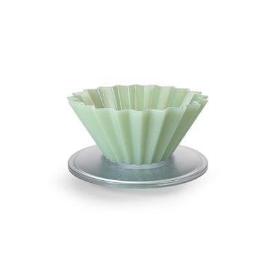 Matte green fluted pour over dripper on a white background.