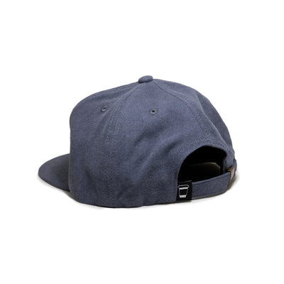 A blue baseball cap shown from the back, with an adjustable strap and a small cup icon tag on the right side.