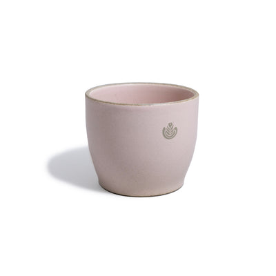 Pink porcelain mug with rosetta design.