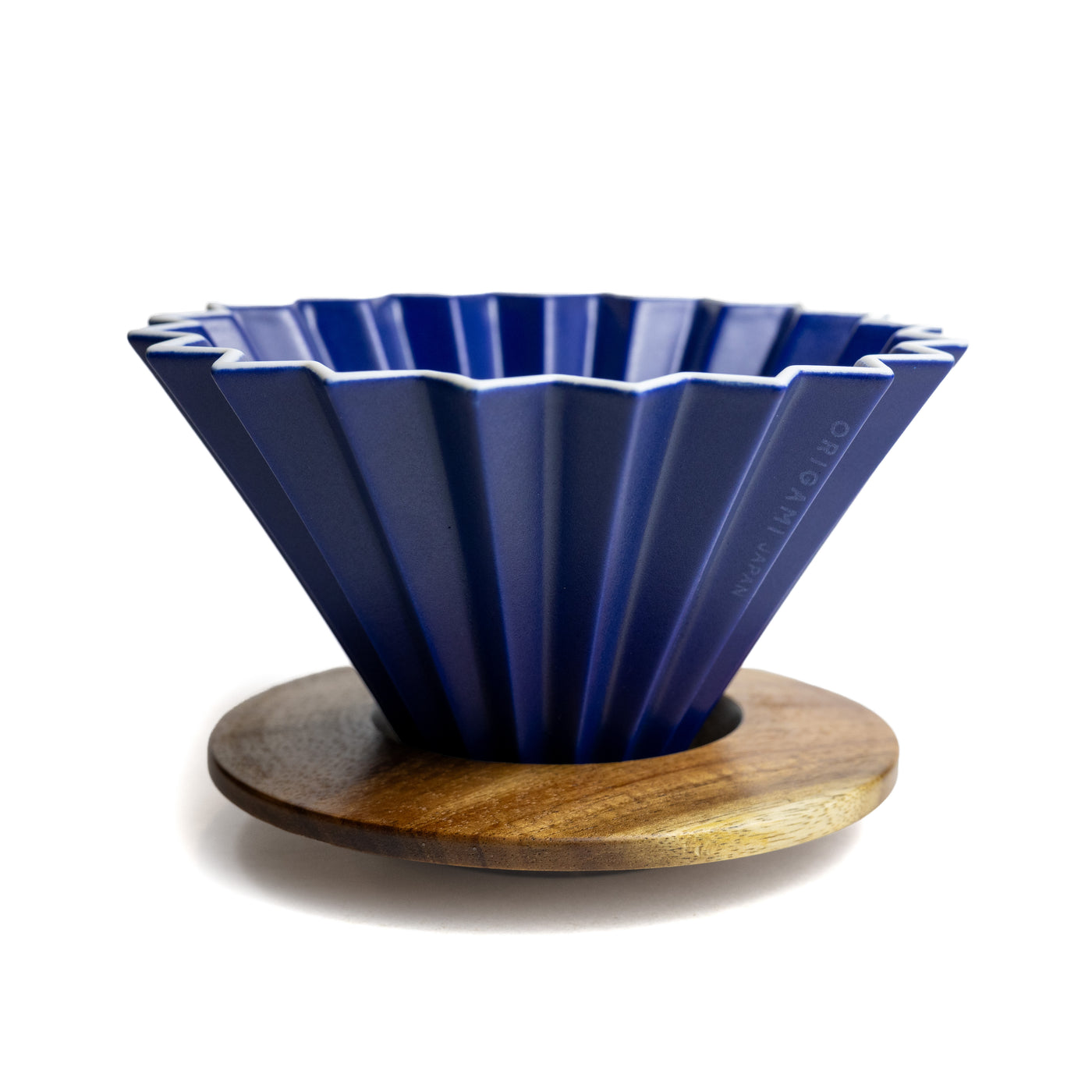 A blue origami dripper with wooden holder.