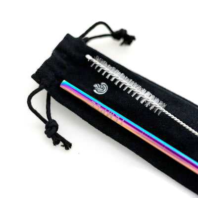 Closeup of iridescent metal straw engraved with the 'Temple' logo, accompanied by a straw-cleaning tool, resting on a black fabric carrying case featuring the Rosetta logo.