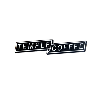 Die cut sticker featuring the words “Temple Coffee” displayed across a stylized ribbon design.