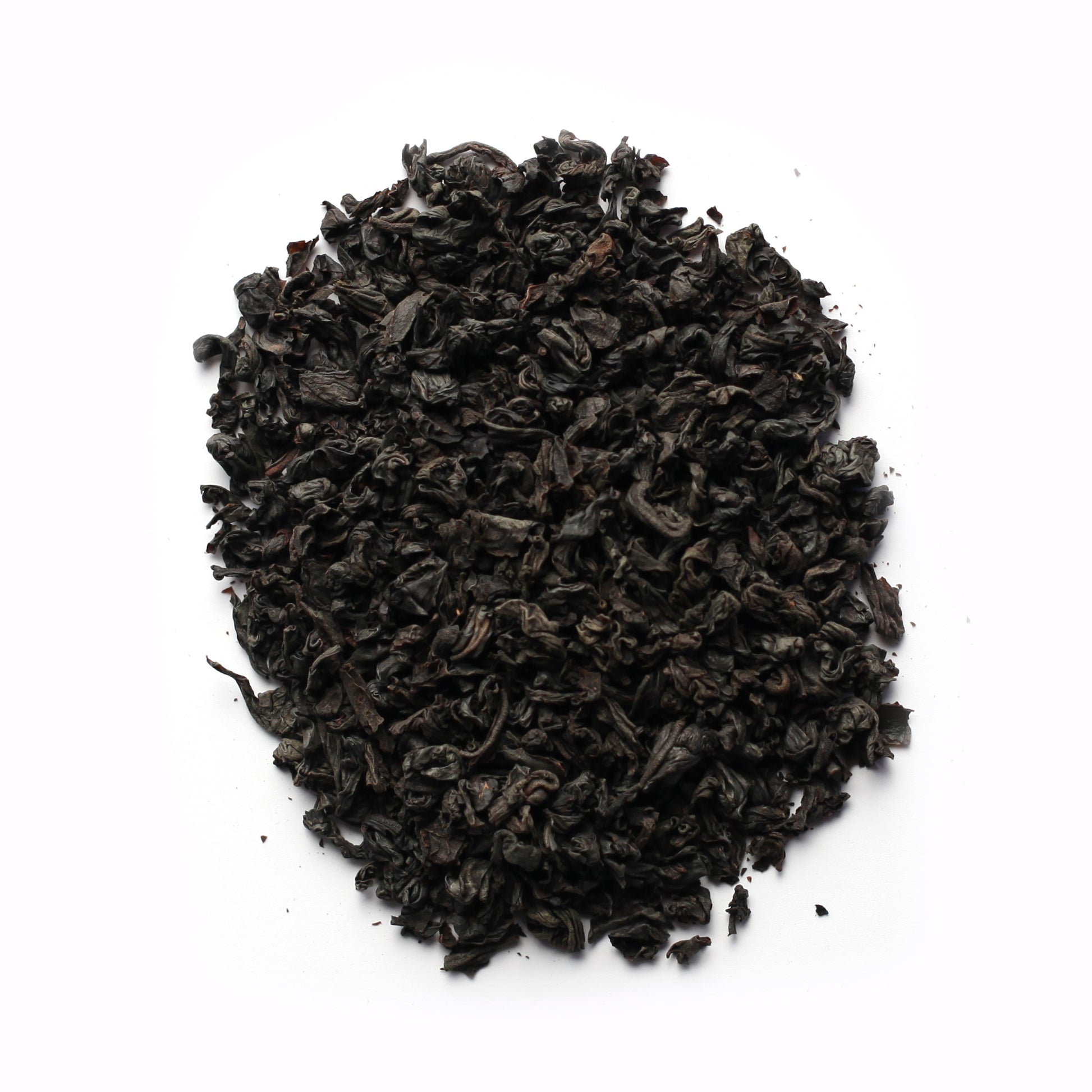 A close-up of black tea leaves on a white background.